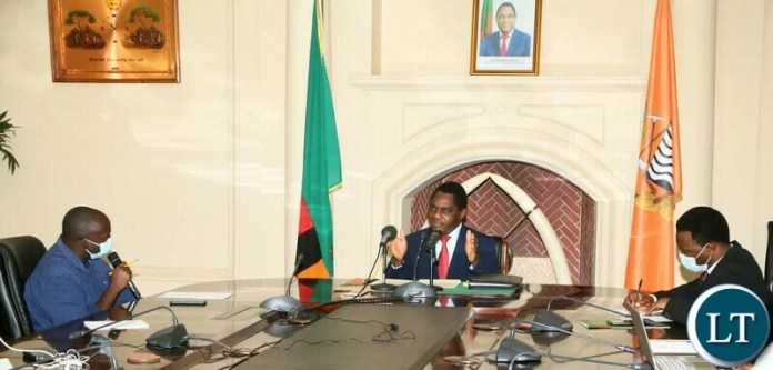 President Hakainde Hichilema answering questions from Radio Phoenix presenter Luciano Hambote during the live radio broadcast at state house whilst Special Assistant to the President for Press and Public relations Anthony Bwalya looks