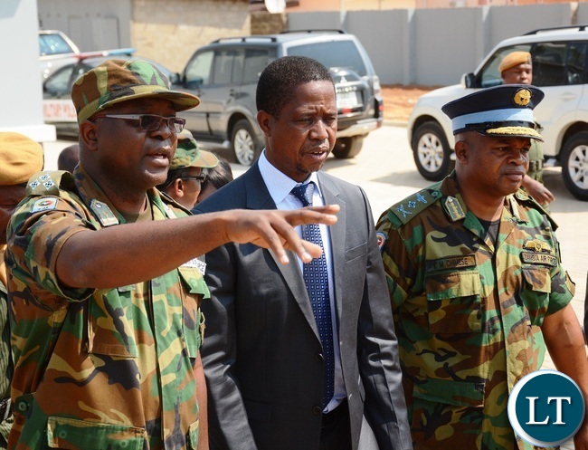 Zambia Air Force Chief of Technical Services Gen Stephen Kabanda(l) explains to President Lungu(c) and Zambia Air force Commander Lt Gen Eric Chimese(r) during the official opening of Zambia Air Force Hospital