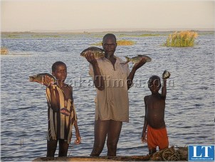 A Sinazongwe fisherman with his children on Lake Kariba