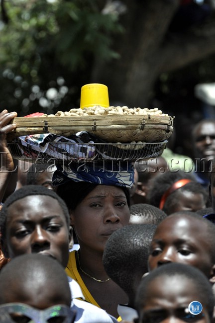 An enterprising youth selling ground nuts on the sidelines of the Youth Day march past