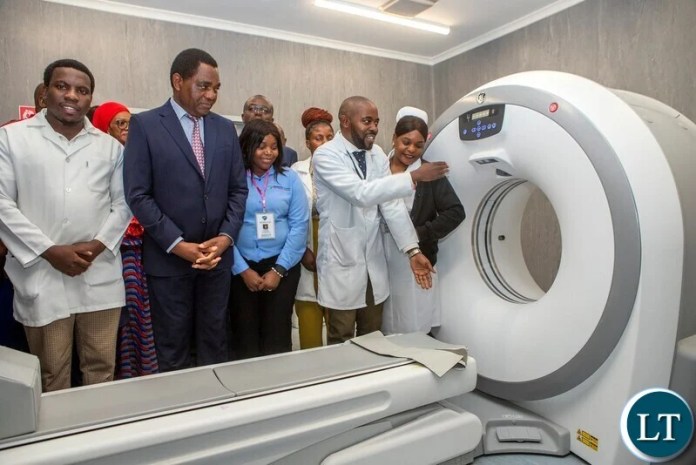 President Hakainde Hichilema being shown a CT scanner