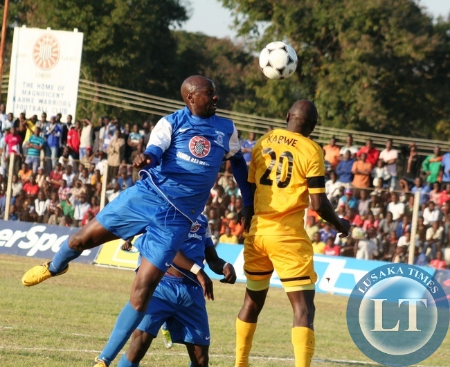 Kabwe Warriors striker Owen Mwendabai (left) in an aerial fight for the ball with Power Dynamos Defender Kamuzati Kabwe during FAZ - MTN week 16 match played at Godfrey Chitalu Stadium in Kabwe yesterday . Power beat Warriors 3- 2